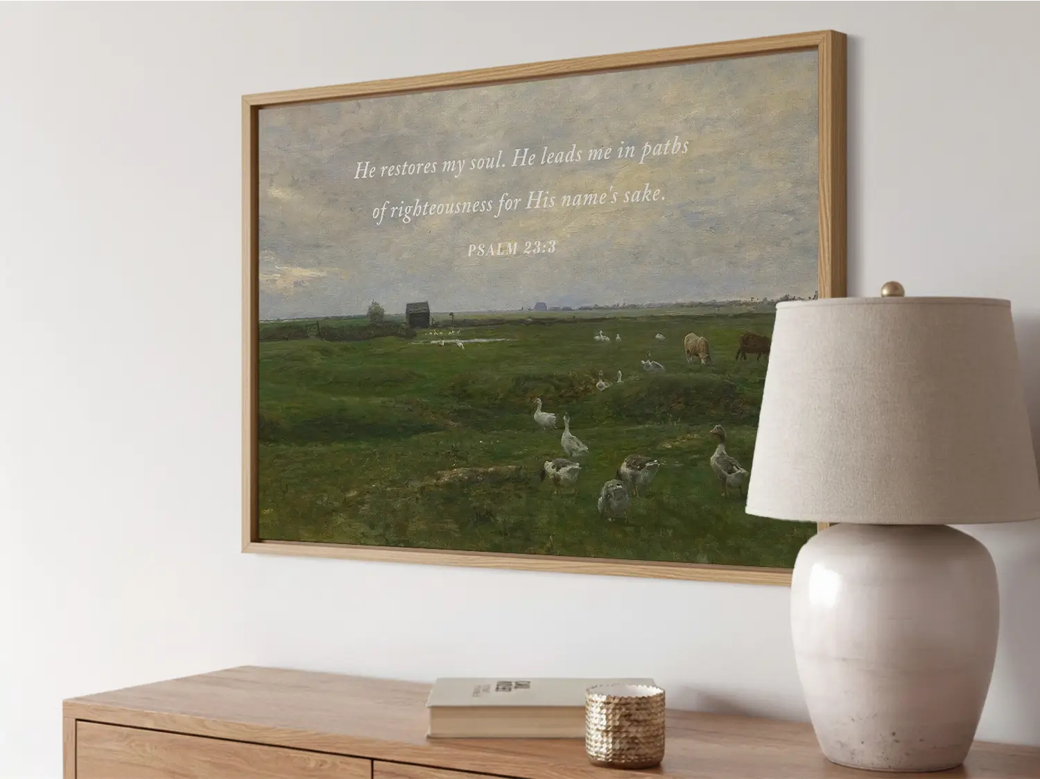 Invite peace and renewal into your space with this inspiring Christian wall art. This framed print features a calming pastoral landscape paired with the comforting promise from Psalm 23:3 about the restoration of the soul.