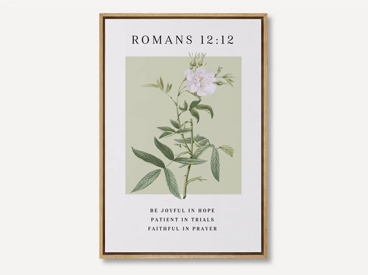Anchor your heart in hope and resilience with this inspiring Christian canvas wall art. This framed canvas print features a calming botanical illustration paired with the powerful encouragement from Romans 12:12 to be joyful, patient, and faithful.