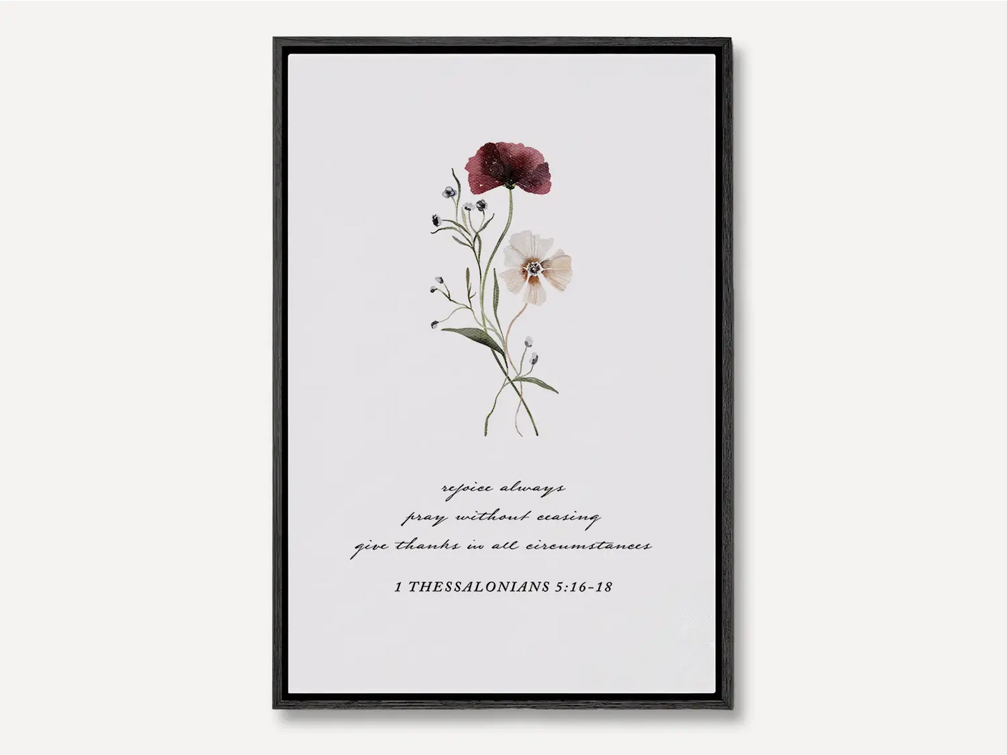Anchor your heart in daily joy and gratitude with this inspiring Christian canvas wall art. This framed canvas print features a delicate watercolor floral illustration paired with the essential life commands from 1 Thessalonians 5:16-18.