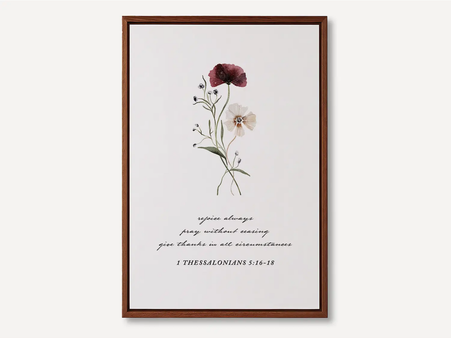 Anchor your heart in daily joy and gratitude with this inspiring Christian canvas wall art. This framed canvas print features a delicate watercolor floral illustration paired with the essential life commands from 1 Thessalonians 5:16-18.