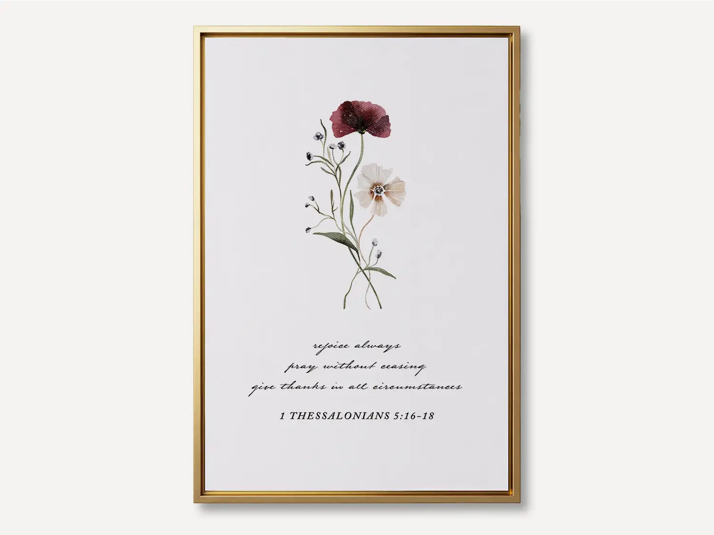 Anchor your heart in daily joy and gratitude with this inspiring Christian canvas wall art. This framed canvas print features a delicate watercolor floral illustration paired with the essential life commands from 1 Thessalonians 5:16-18.