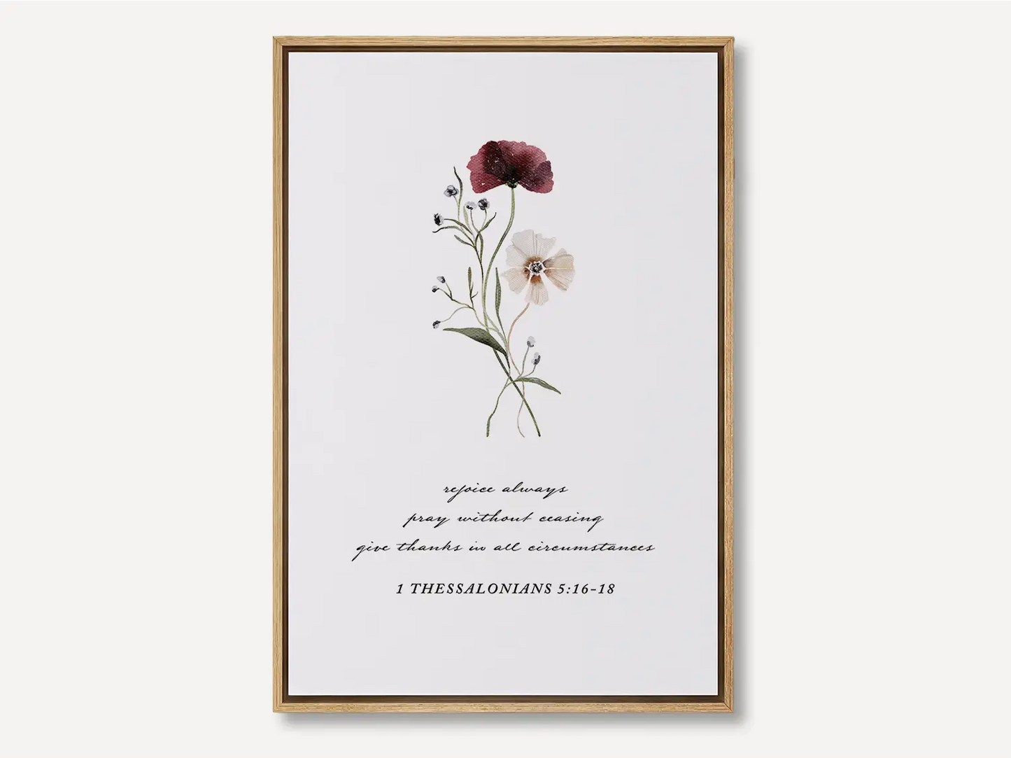 Anchor your heart in daily joy and gratitude with this inspiring Christian canvas wall art. This framed canvas print features a delicate watercolor floral illustration paired with the essential life commands from 1 Thessalonians 5:16-18.