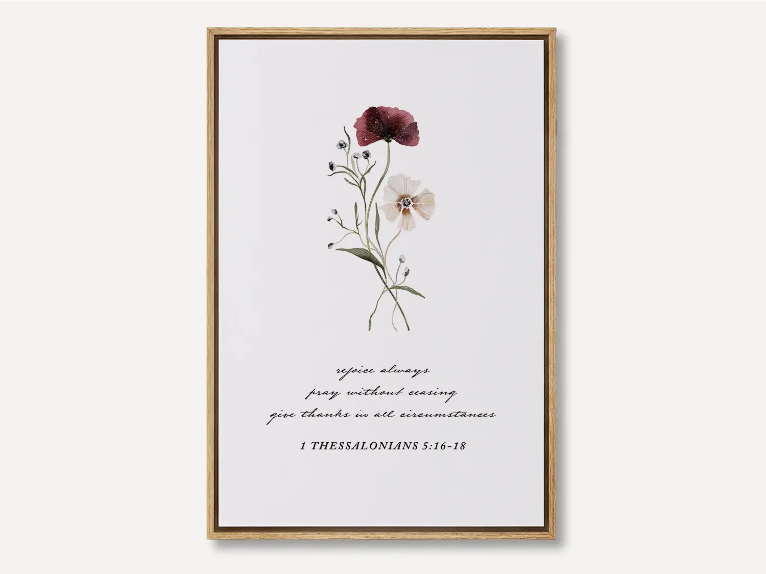 Anchor your heart in daily joy and gratitude with this inspiring Christian canvas wall art. This framed canvas print features a delicate watercolor floral illustration paired with the essential life commands from 1 Thessalonians 5:16-18.