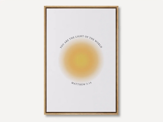 Shine brightly and inspire others with this powerful Christian canvas wall art. This framed canvas print features a modern, ethereal "aura" design and the profound command from Matthew 5:14: "You are the light of the world."