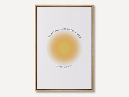 Shine brightly and inspire others with this powerful Christian canvas wall art. This framed canvas print features a modern, ethereal "aura" design and the profound command from Matthew 5:14: "You are the light of the world."