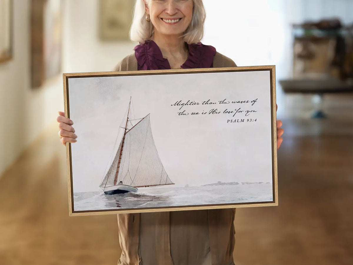 Anchor your heart in unwavering love with this inspiring Christian wall art. This framed print features a serene sailboat painting paired with the powerful promise from Psalm 93:4: "Mightier than the waves of the sea is His love for you."