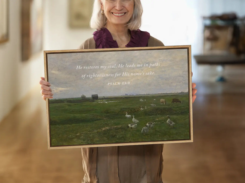 Invite peace and renewal into your space with this inspiring Christian wall art. This framed print features a calming pastoral landscape paired with the comforting promise from Psalm 23:3 about the restoration of the soul.