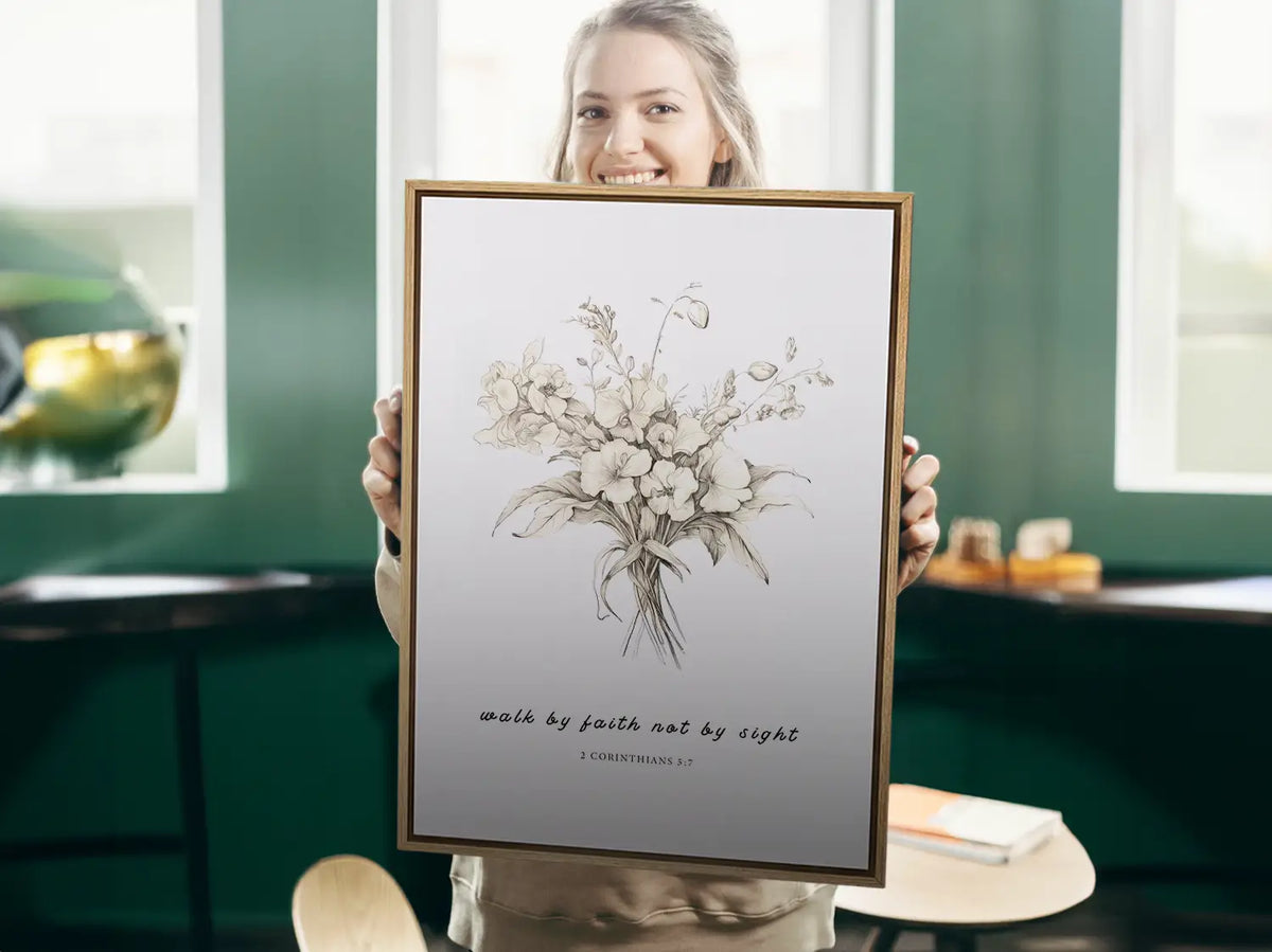 Anchor your life in trust with this inspiring Christian canvas wall art. This framed canvas print features an elegant floral sketch paired with the guiding scripture from 2 Corinthians 5:7: "Walk by faith not by sight."