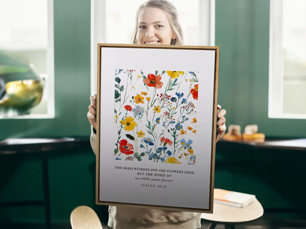 Anchor your hope in unchanging truth with this inspiring Christian canvas wall art. This framed canvas print features a vibrant watercolor floral design paired with the powerful promise from Isaiah 40:8: "The word of our God will stand forever."