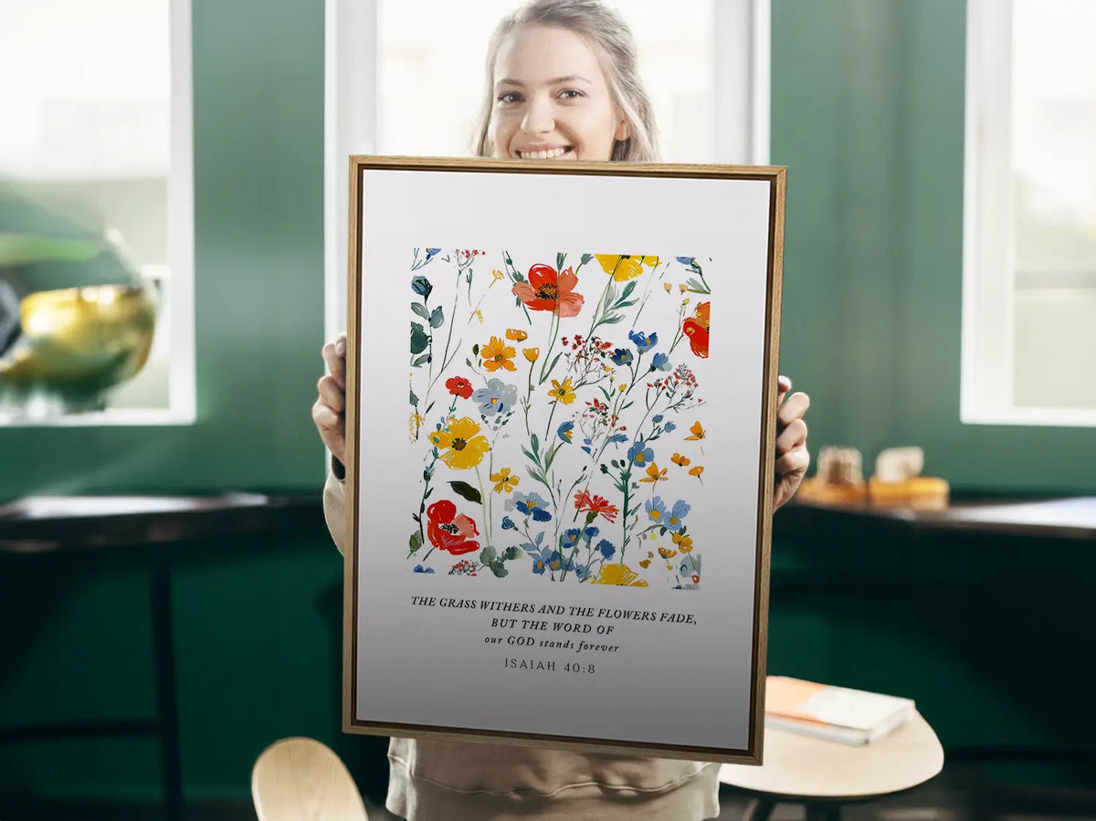 Anchor your hope in unchanging truth with this inspiring Christian canvas wall art. This framed canvas print features a vibrant watercolor floral design paired with the powerful promise from Isaiah 40:8: "The word of our God will stand forever."