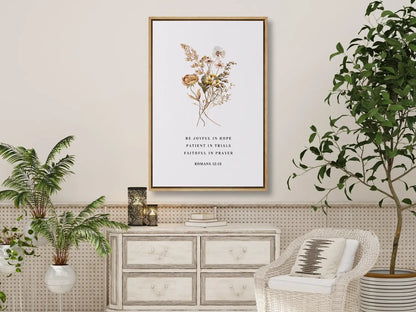 Anchor your heart in hope and resilience with this inspiring Christian canvas wall art. This framed canvas print features a beautiful pressed floral illustration paired with the powerful encouragement from Romans 12:12 to be joyful, patient, and faithful.