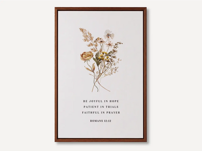Anchor your heart in hope and resilience with this inspiring Christian canvas wall art. This framed canvas print features a beautiful pressed floral illustration paired with the powerful encouragement from Romans 12:12 to be joyful, patient, and faithful.
