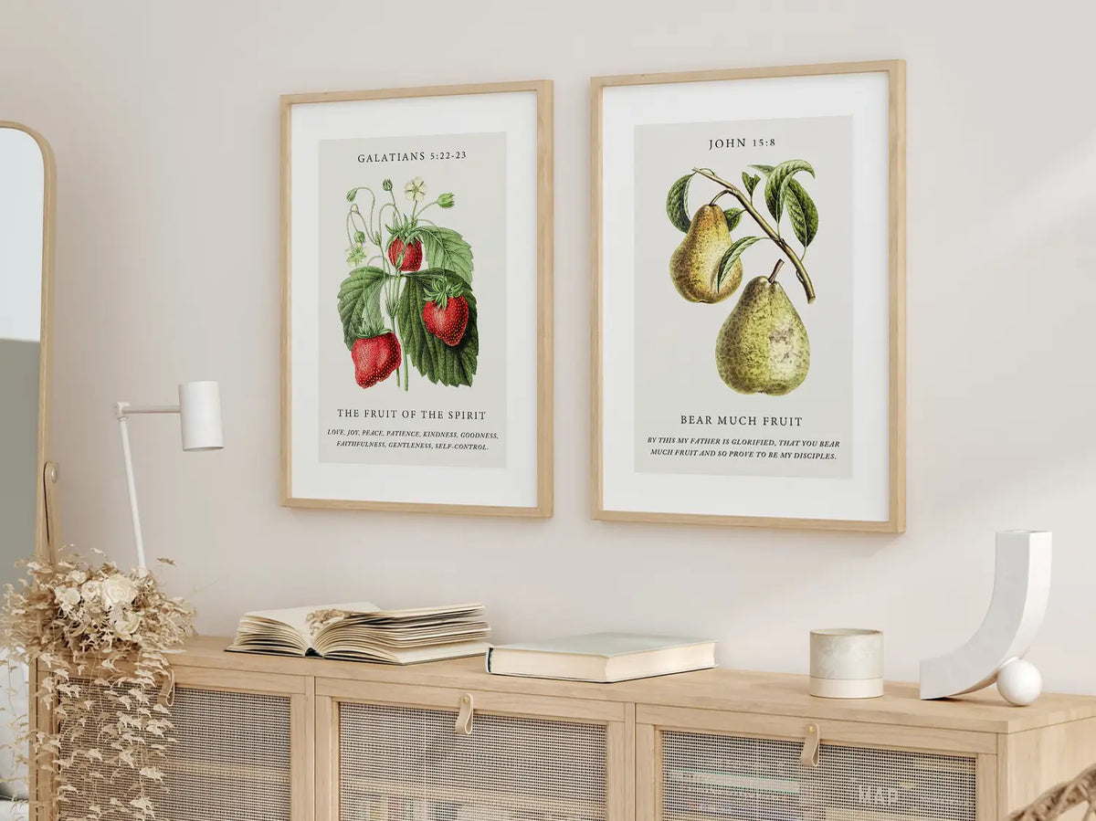 Decorate your home with this beautiful Christian wall art set. This collection of two framed botanical prints features detailed illustrations of fruit, paired with powerful verses on the Fruit of the Spirit and bearing spiritual fruit.