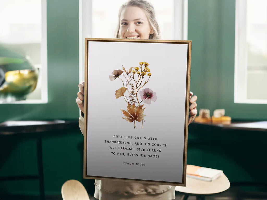 Close-up of pressed floral artwork and Psalm 100:4 text on Christian canvas wall art