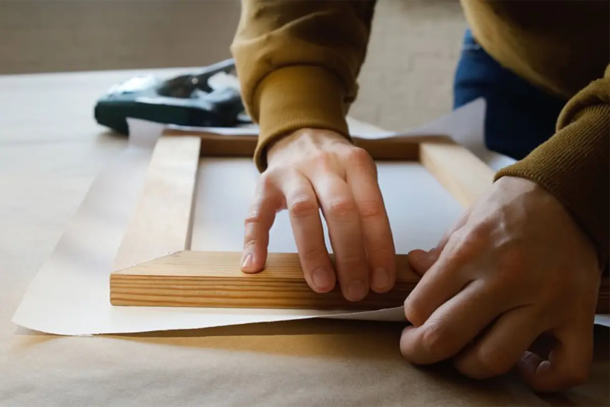 Hand-stretching the canvas over the frame