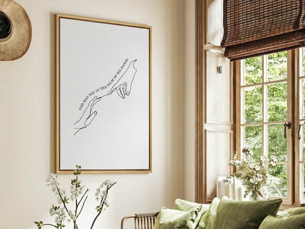 Find comfort and security in God's grasp with this inspiring Christian canvas wall art. This framed canvas print features a beautiful, modern line-art illustration of two hands meeting, highlighting the powerful promise from Isaiah 49:16: “God has you in the palm of His hands.”