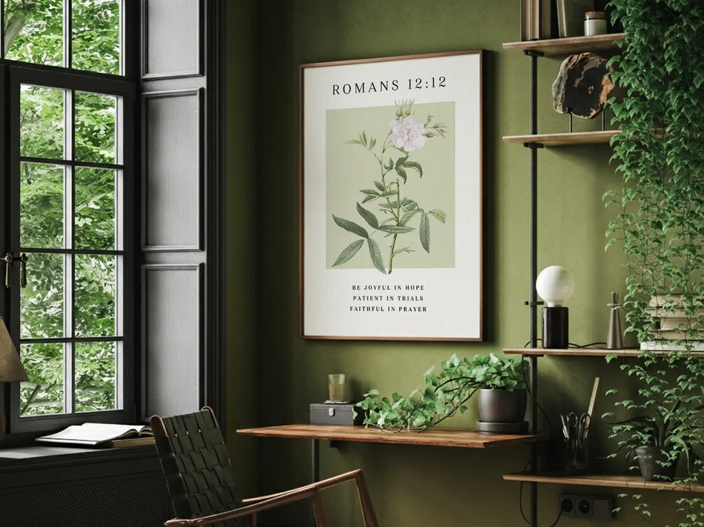 Botanical Christian wall art with Bible verse Romans 12:12 framed and hanging above a neutral sofa