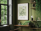 Botanical Christian wall art with Bible verse Romans 12:12 framed and hanging above a neutral sofa