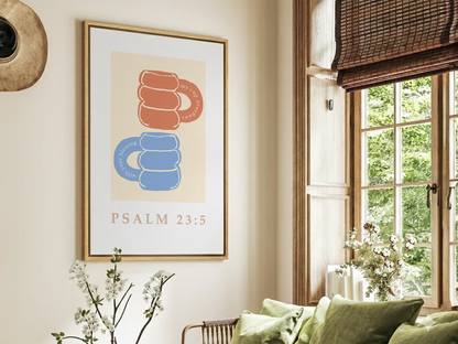 Celebrate abundant blessings with this inspiring Christian canvas wall art. This framed canvas print features a joyful, abstract design of stacked mugs and the comforting promise from Psalm 23:5 that your cup overflows.
