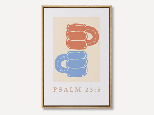 Celebrate abundant blessings with this inspiring Christian canvas wall art. This framed canvas print features a joyful, abstract design of stacked mugs and the comforting promise from Psalm 23:5 that your cup overflows.