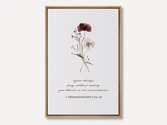 Anchor your heart in daily joy and gratitude with this inspiring Christian canvas wall art. This framed canvas print features a delicate watercolor floral illustration paired with the essential life commands from 1 Thessalonians 5:16-18.