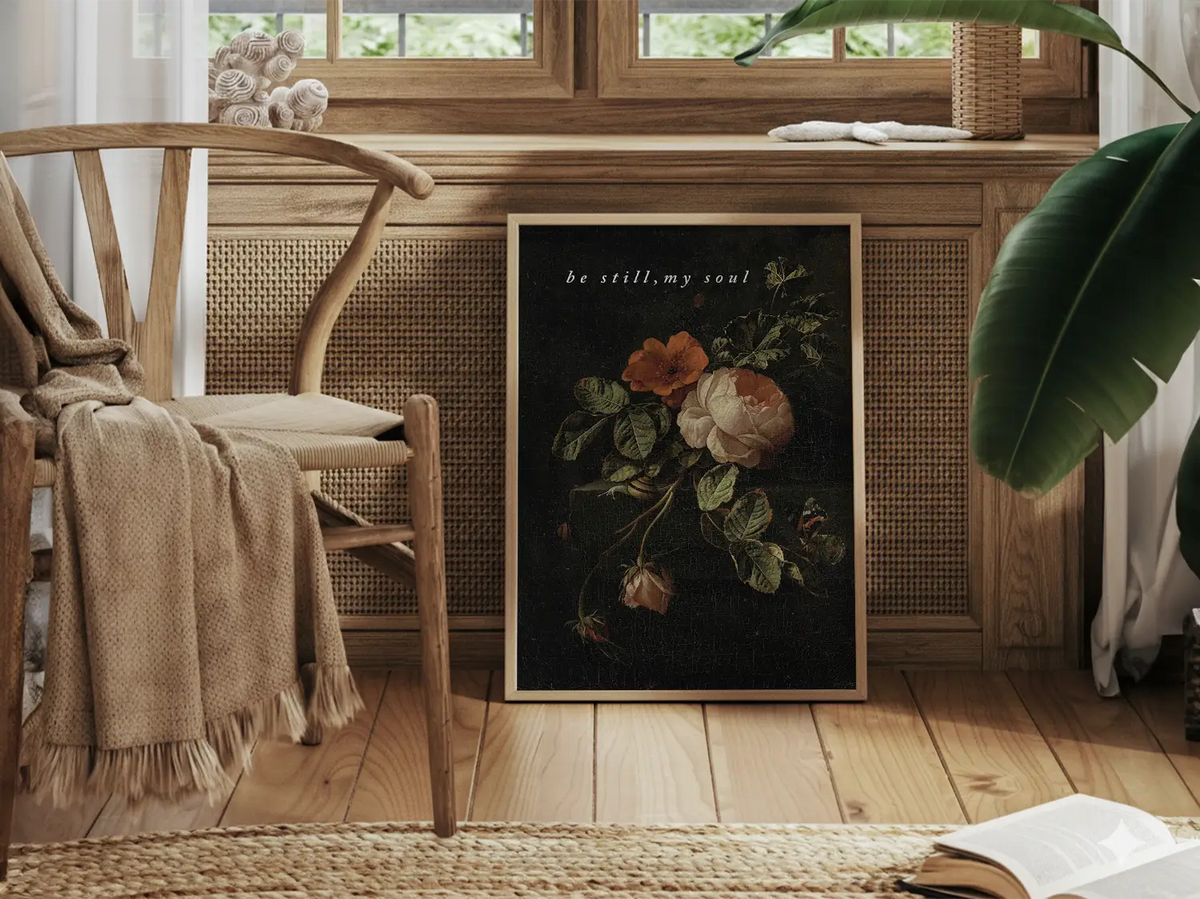Invite deep tranquility and faith into your home with this inspiring Christian canvas wall art. This framed canvas print features a dramatic, dark floral painting paired with the comforting command: “Be still, my soul.”
